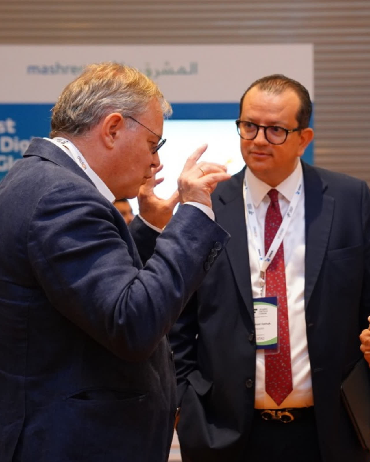 Two senior delegates in conversation at a Vostad forum