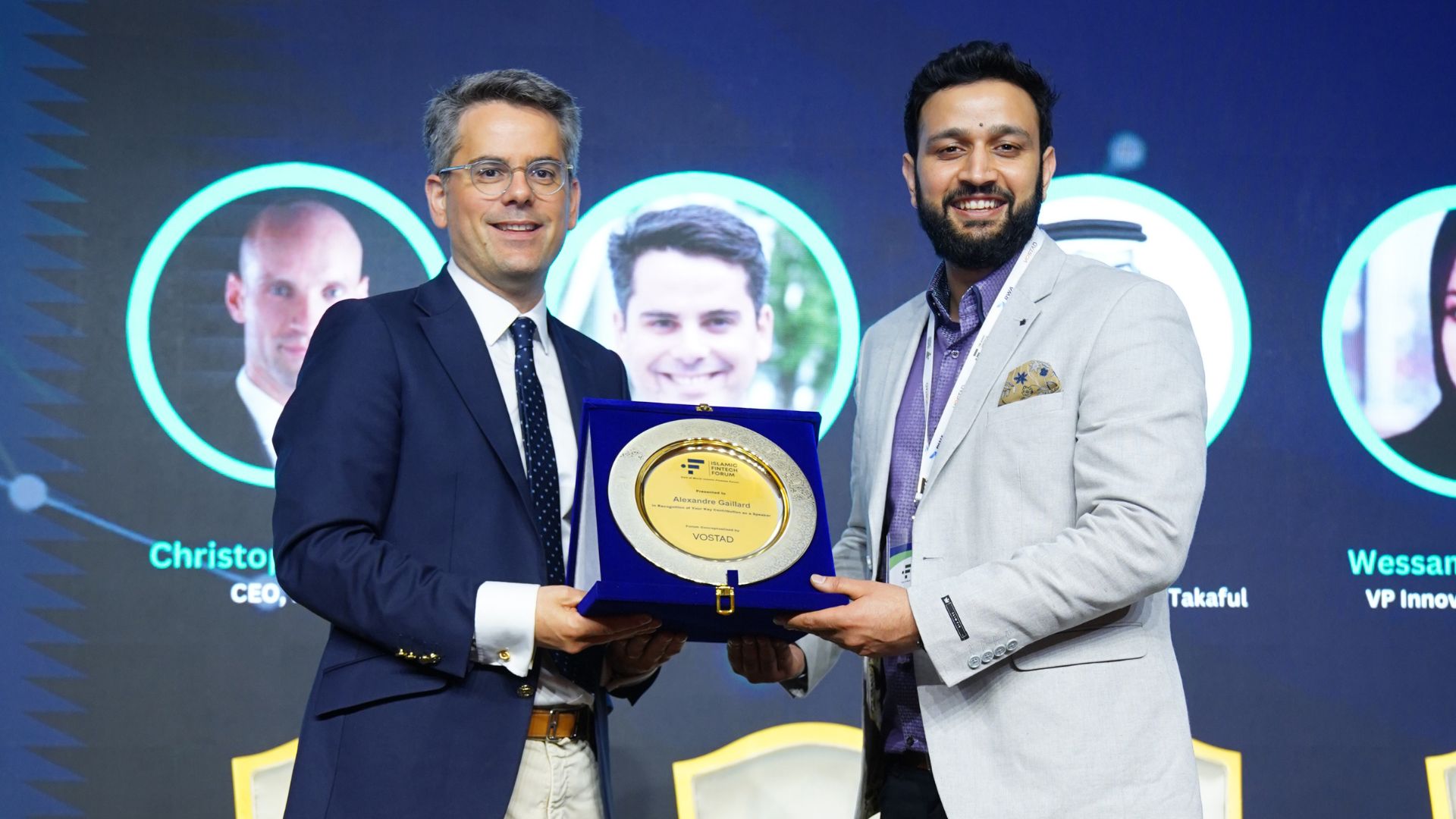 A commemorative plaque presented to a speaker on stage